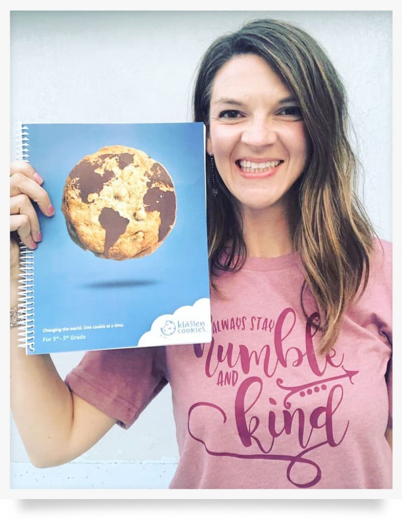 Brittney Mason holding up her Klassen Cookies program book.