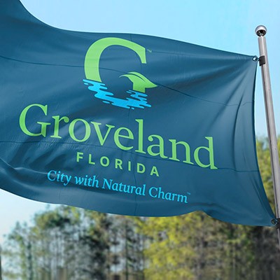 Teal flag featuring the new City of Groveland logo