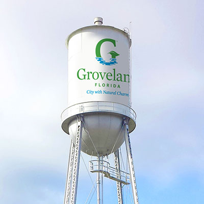 A water tower featuring the new City of Groveland logo.