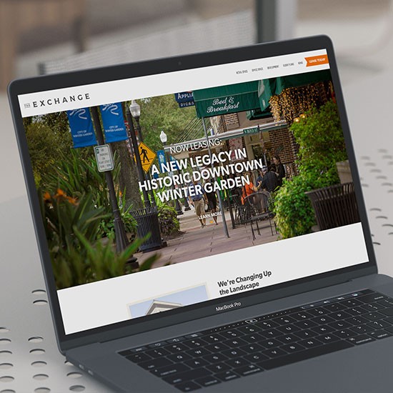 The Exchange website on a laptop.